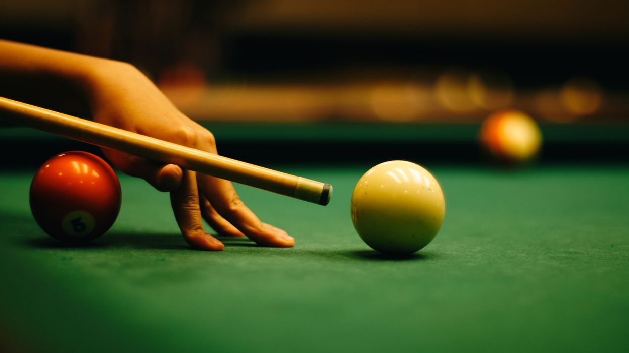 Woman hand playing pool