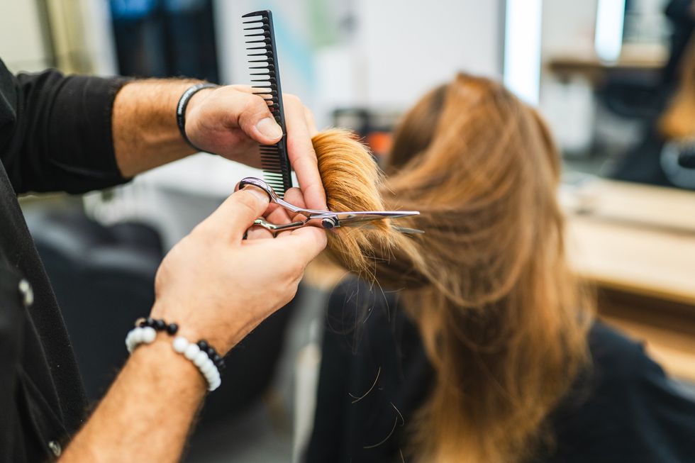 Woman having her hair trimmed