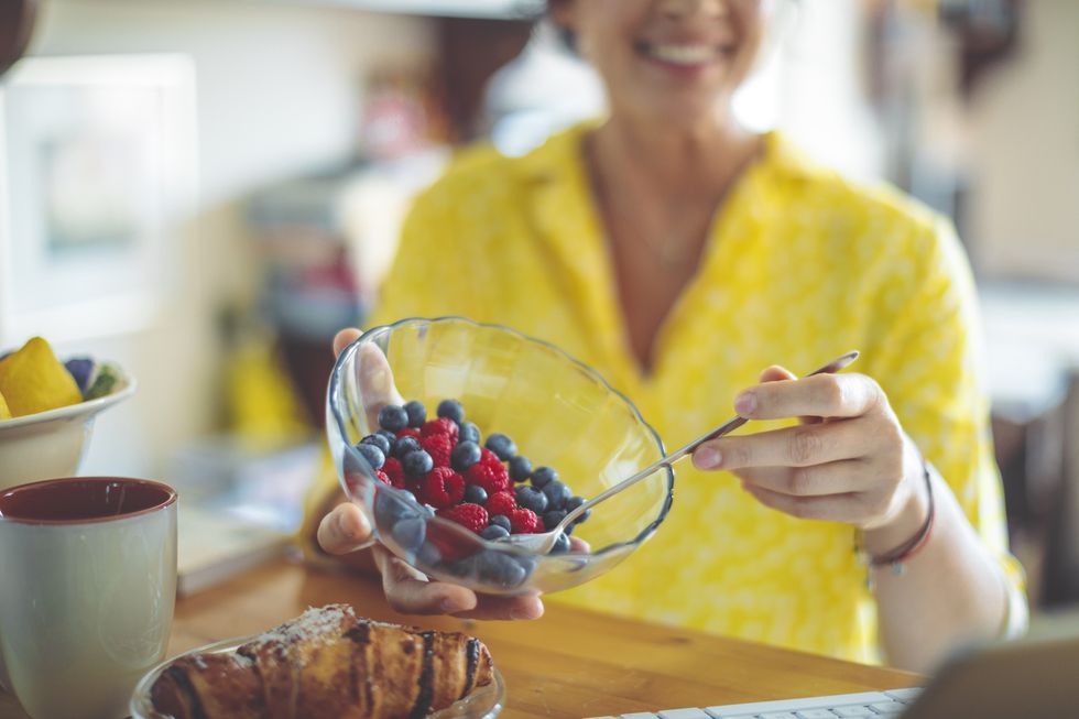 Woman holding a bowl of berries