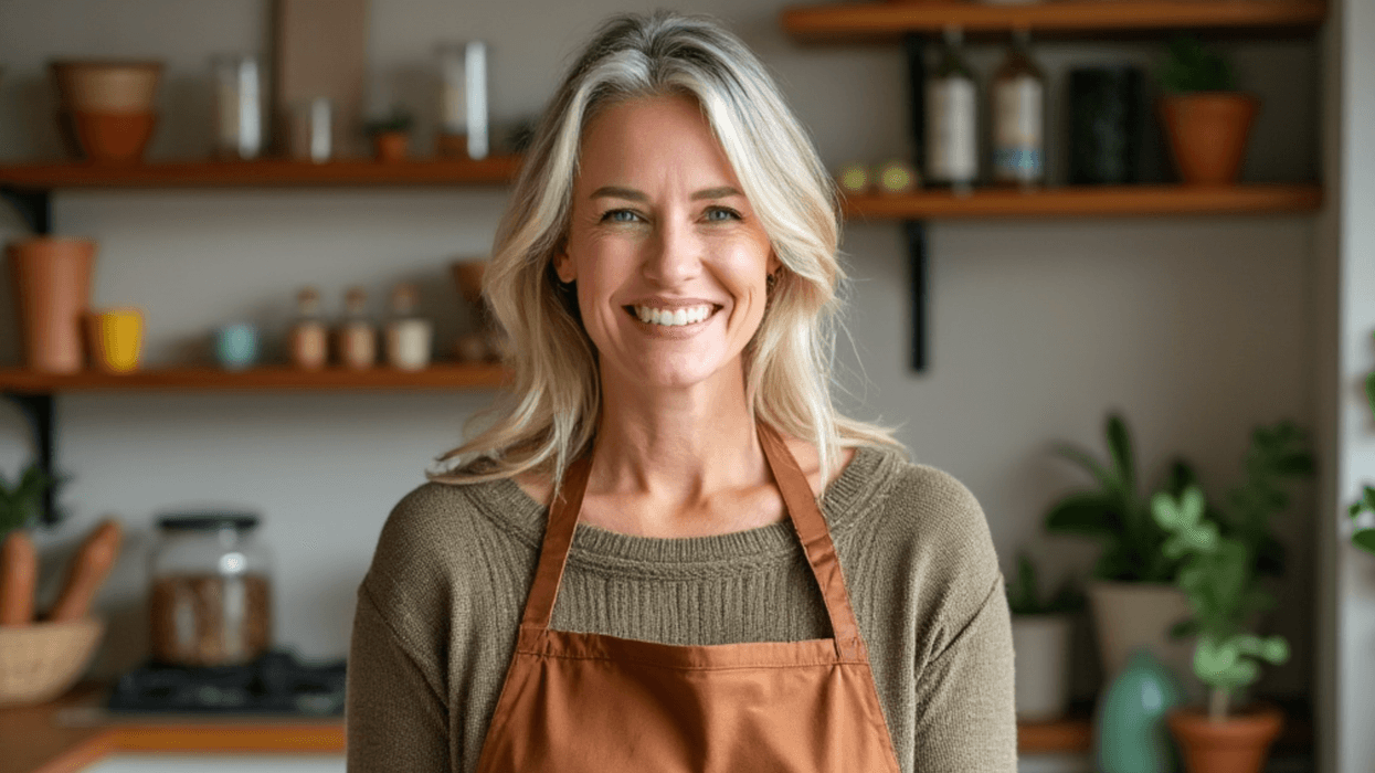 Woman holding a plate of beans