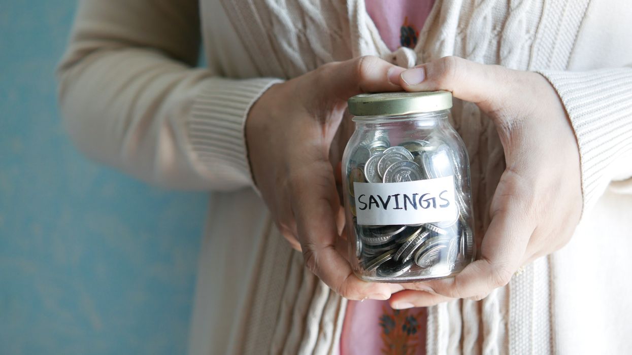 Woman holding a savings money box