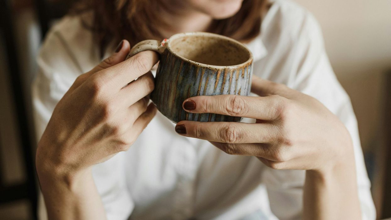 Woman holding cup of coffee