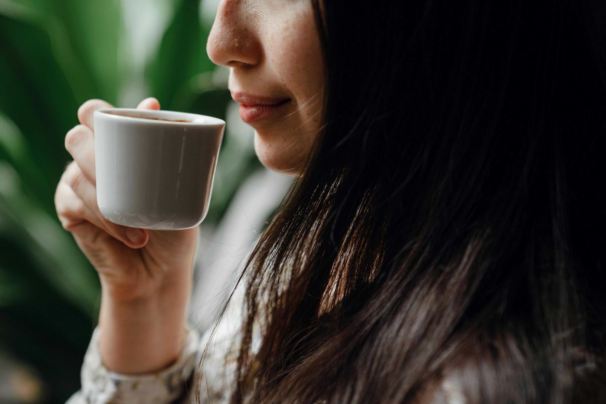 Woman holding cup of espresso