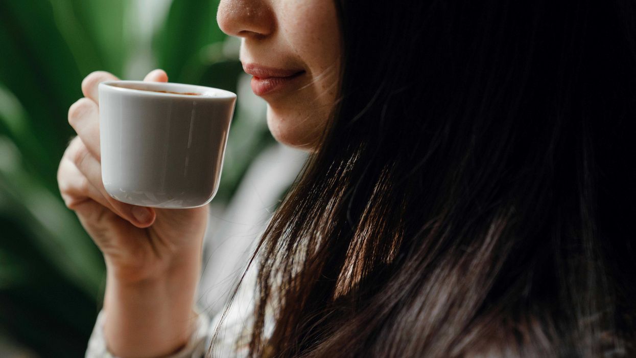 Woman holding cup of espresso
