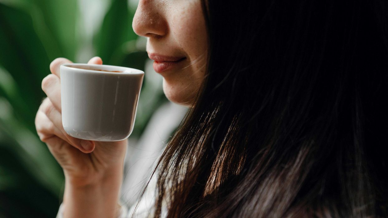 Woman holding cup of espresso