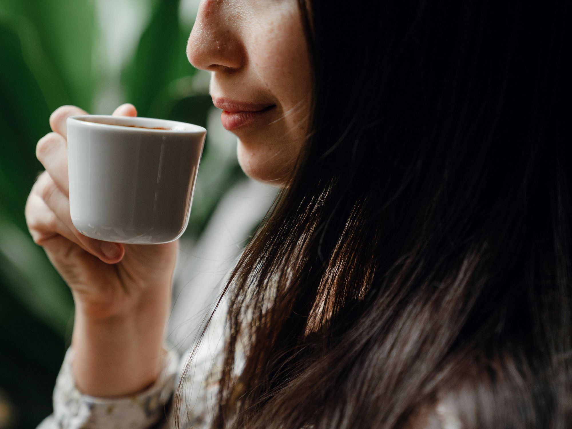 Woman holding cup of espresso