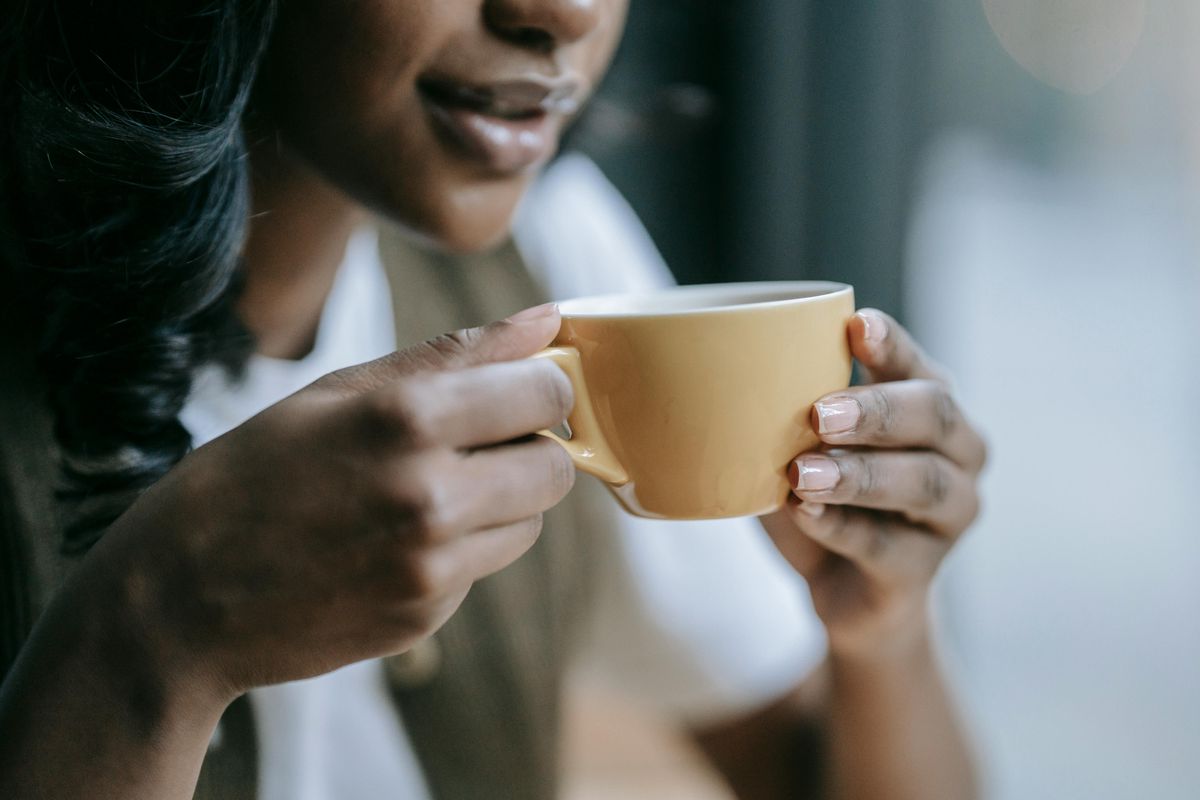 Woman holding cup of espresso