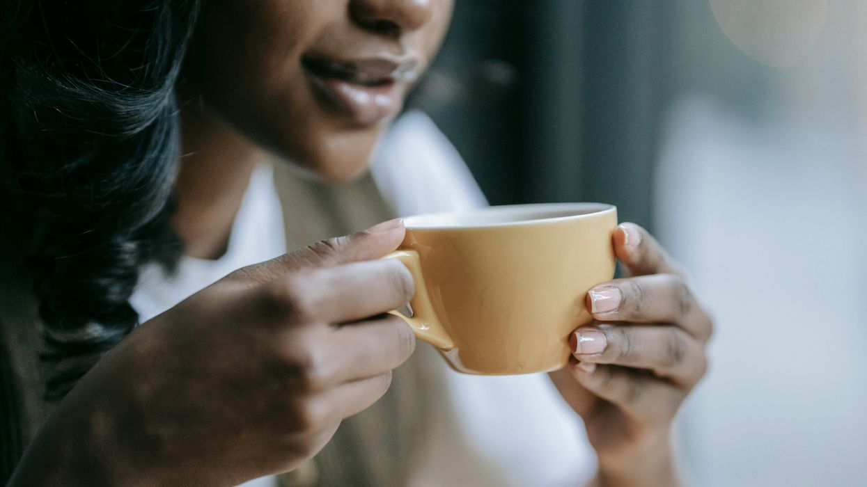 Woman holding cup of espresso