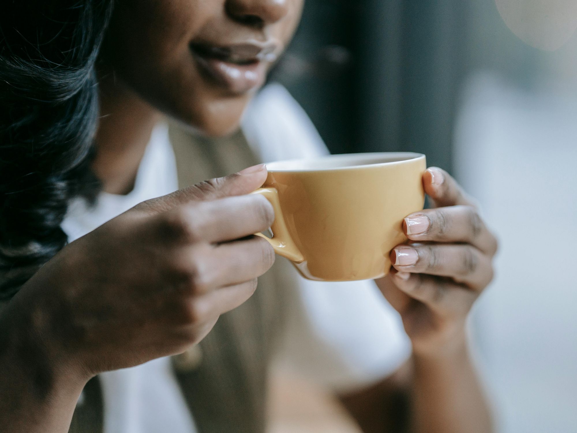 Woman holding cup of espresso