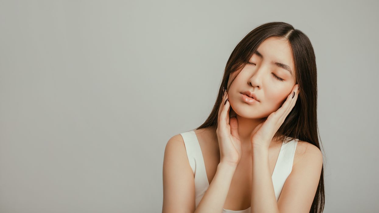 woman holding face