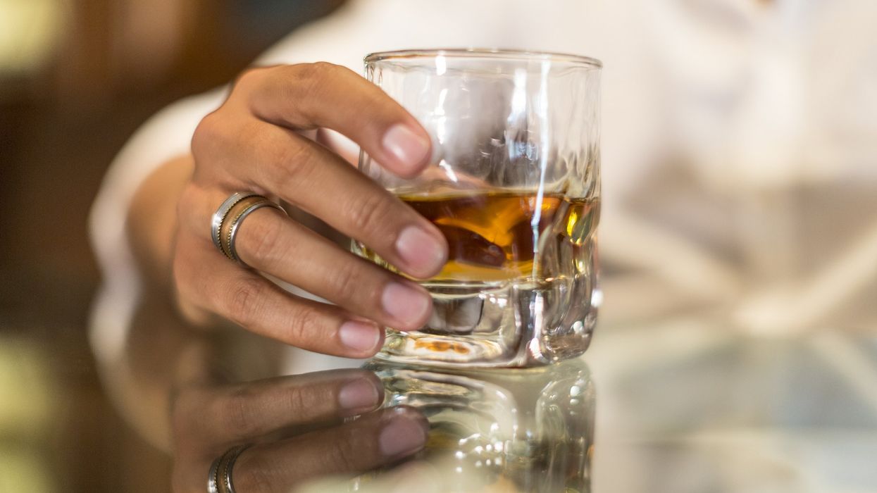 Woman holding glass of whisky