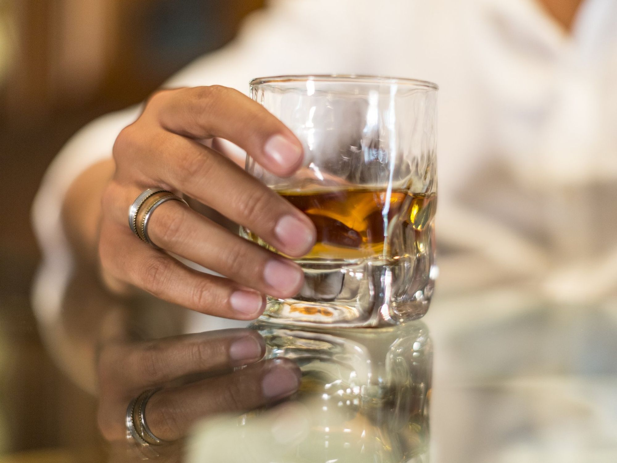Woman holding glass of whisky