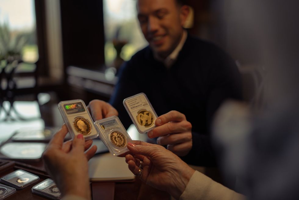 Woman holding gold bullion coins
