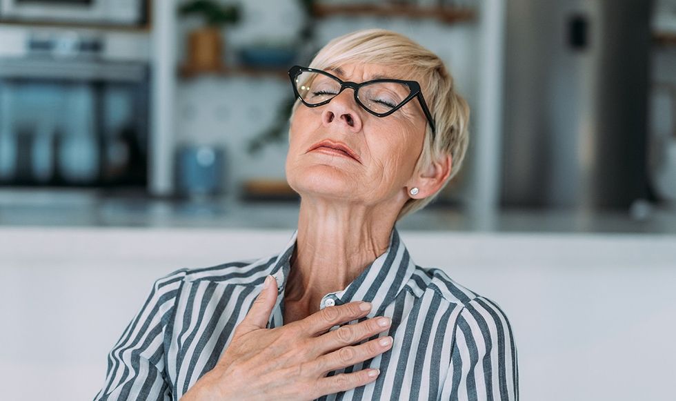 Woman holding her chest