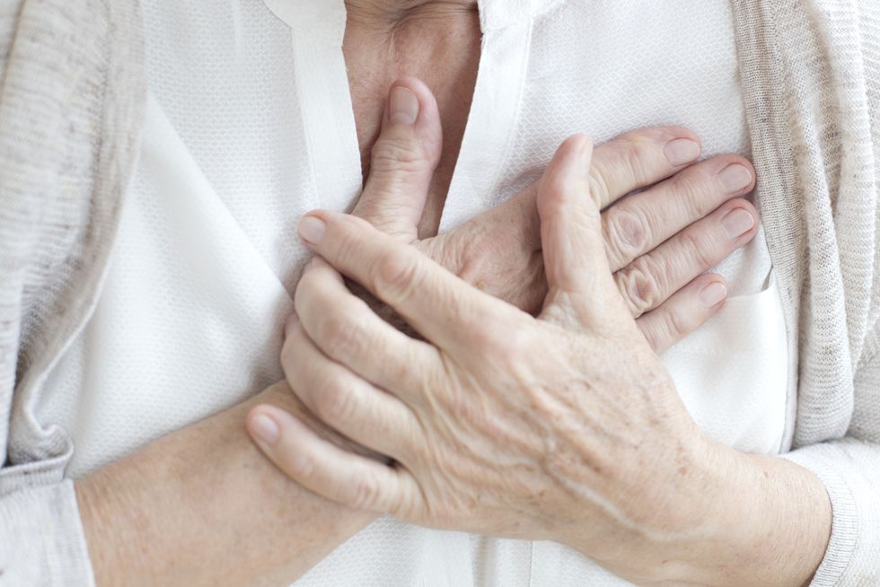 Woman holding her chest