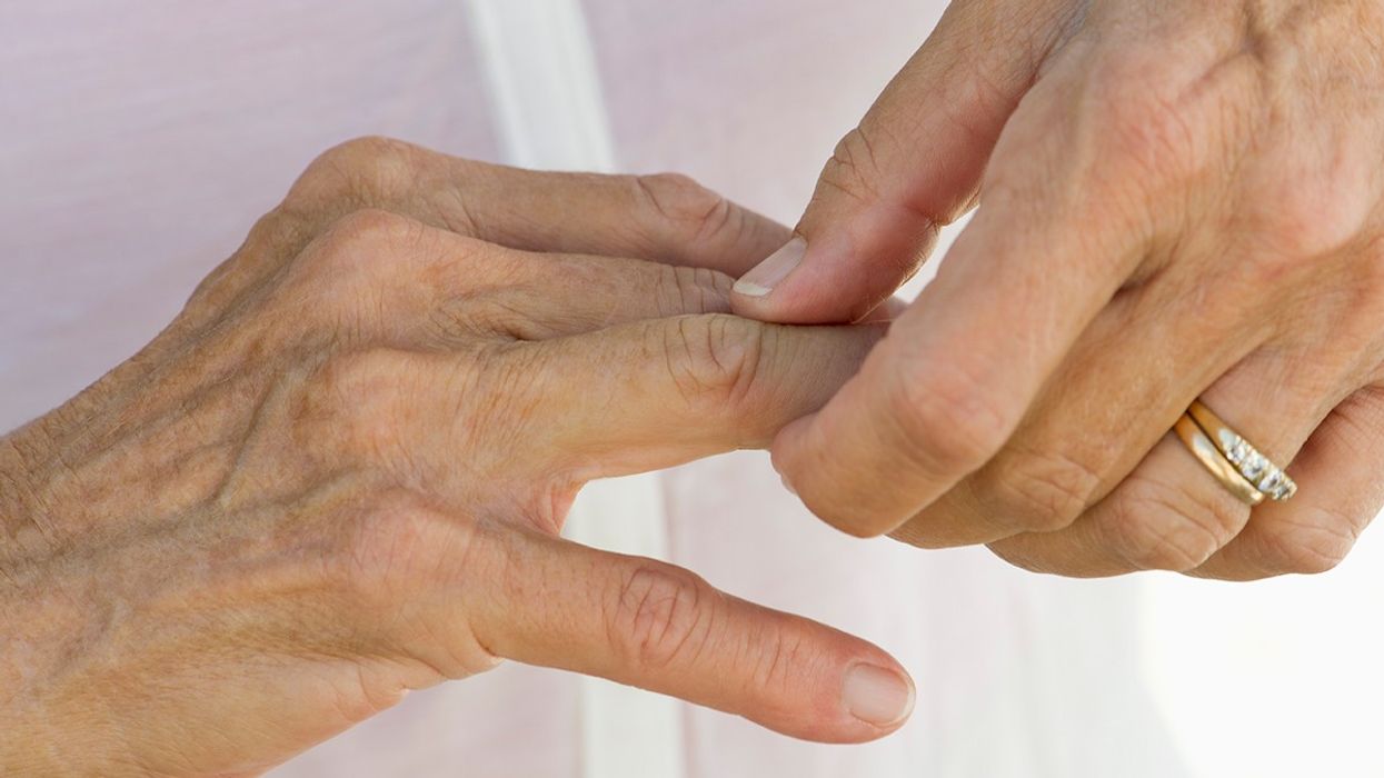 Woman holding her fingers in pain