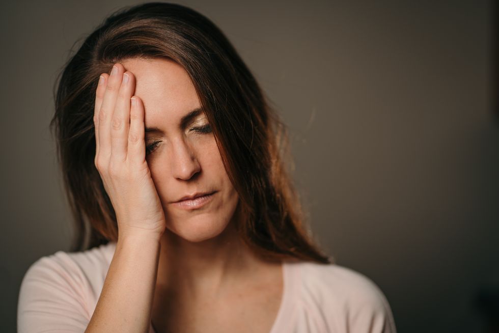 Woman holding her head in pain