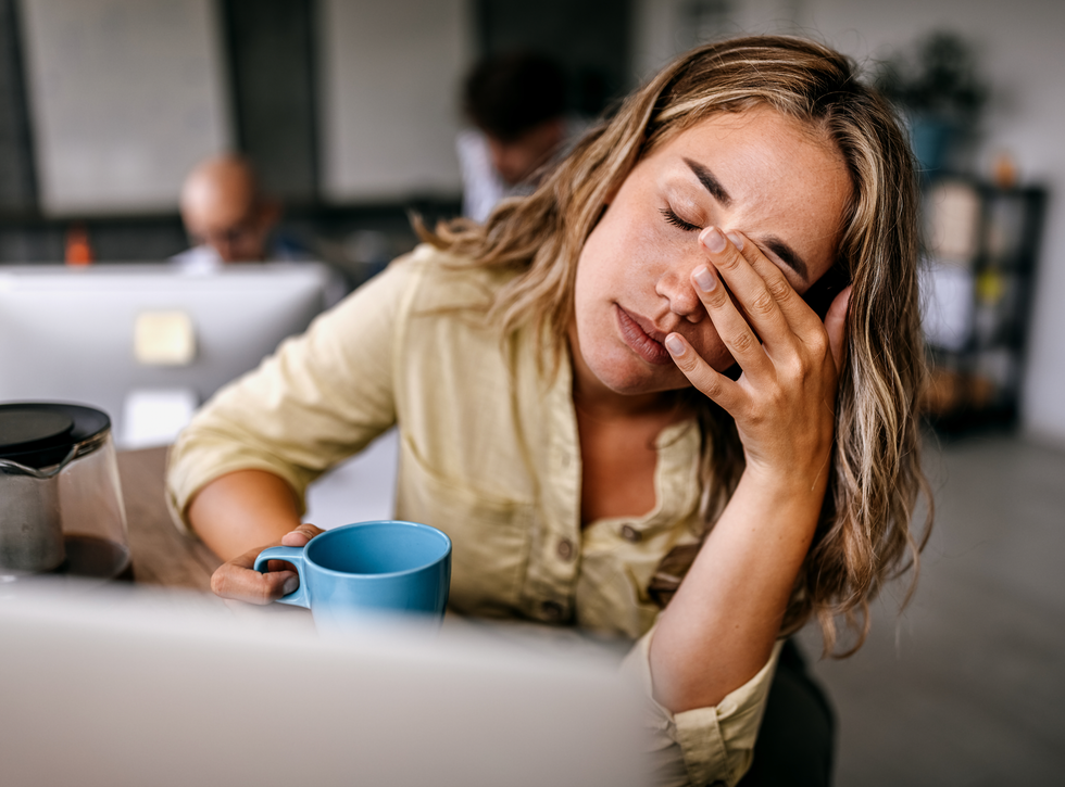 Woman holding her head in pain