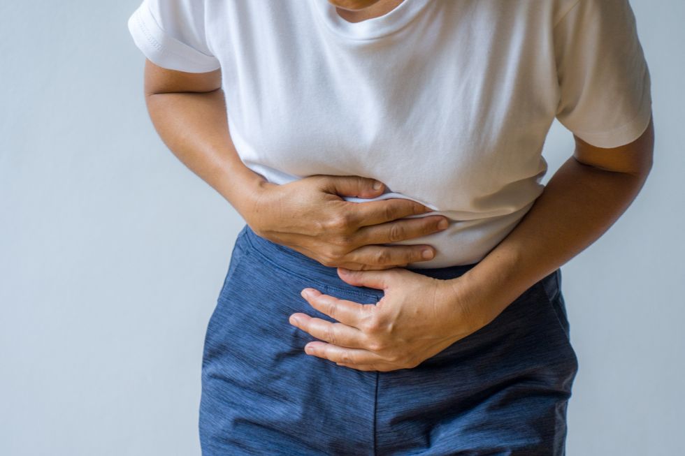Woman holding her stomach in pain