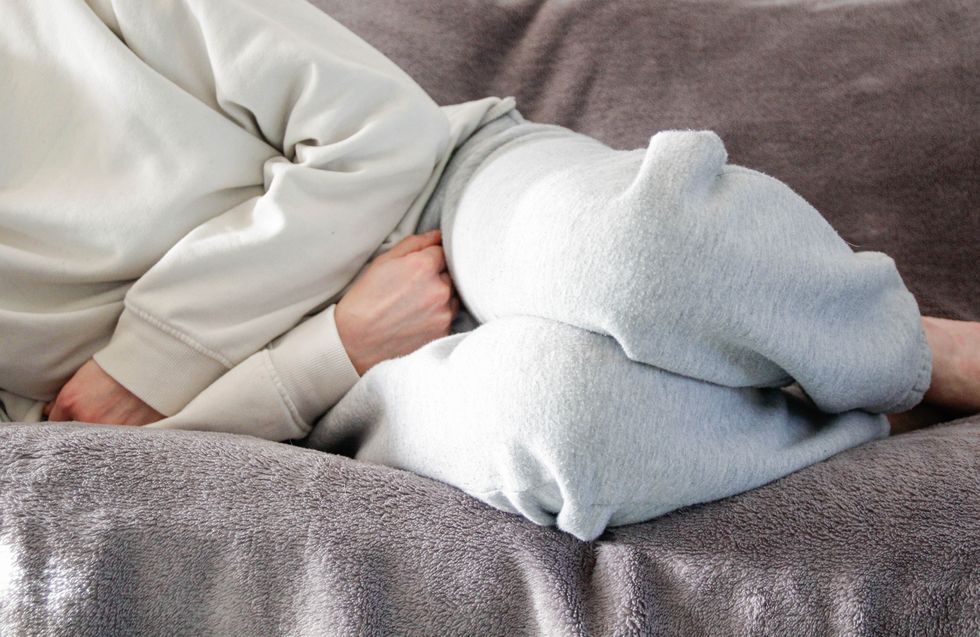 Woman holding her stomach in pain