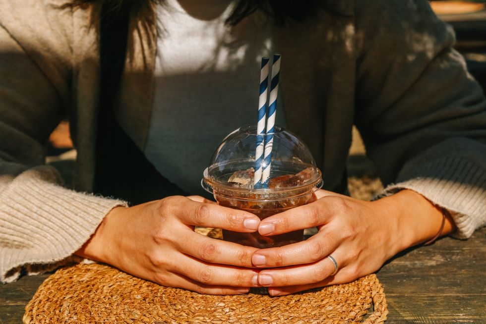 WOMAN HOLDING ICED COFFEE