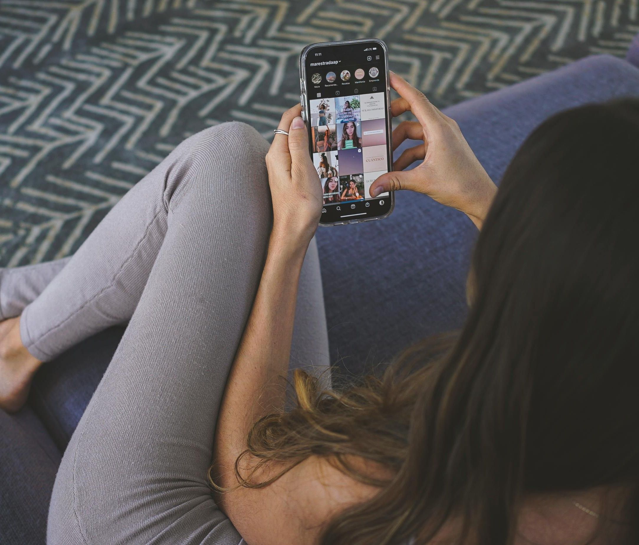Woman holding phone with Instagram app open