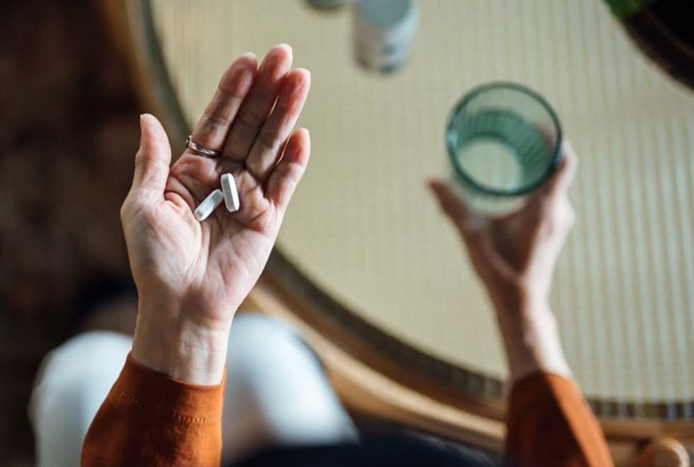 woman holding pill