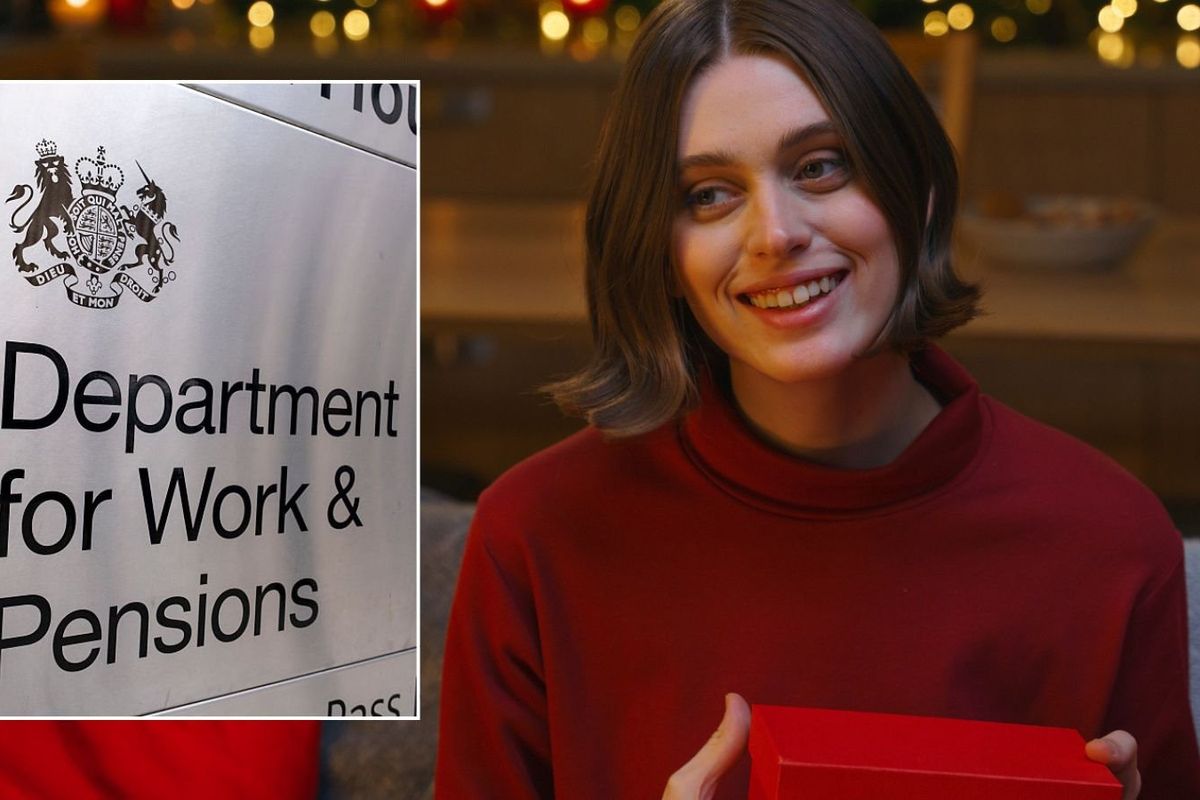 Woman holding present and DWP sign