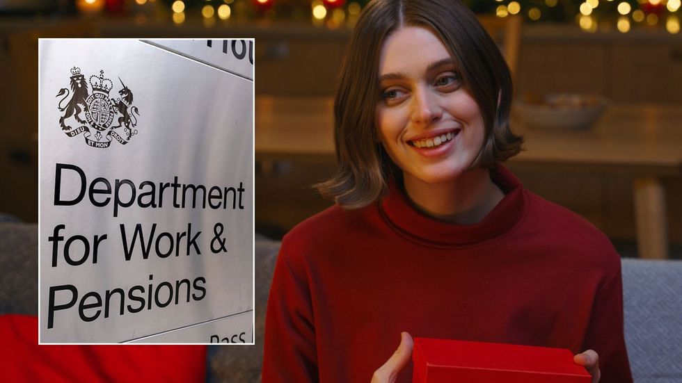 Woman holding present and DWP sign