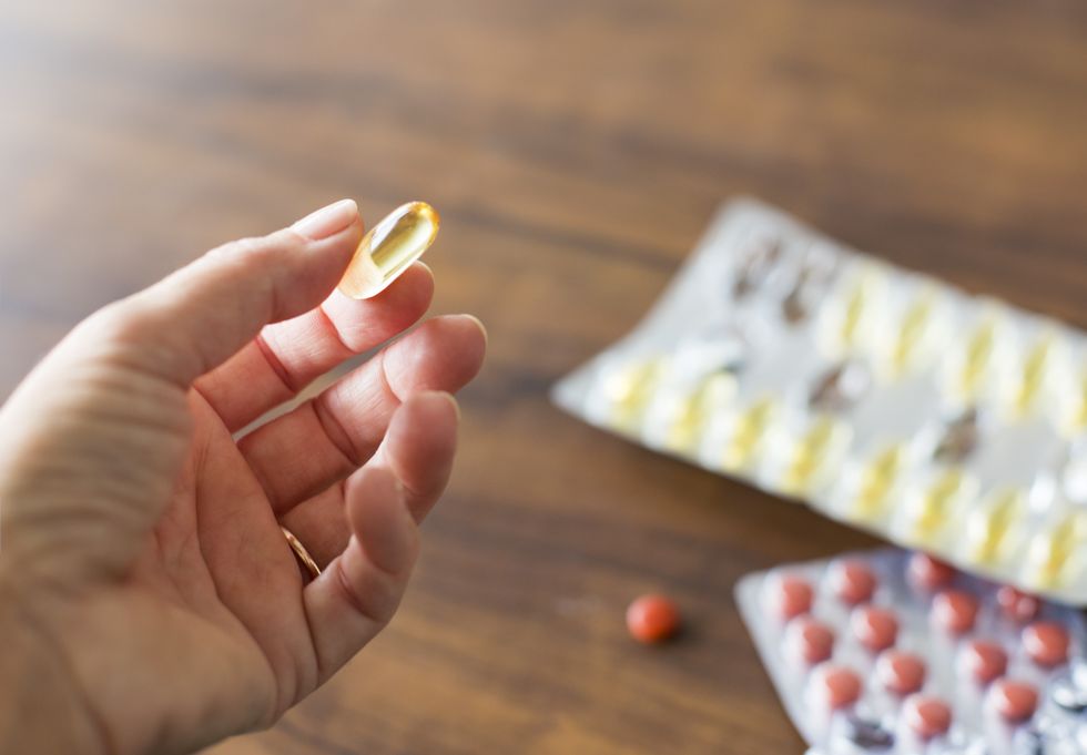 WOMAN HOLDING SUPPLEMENT