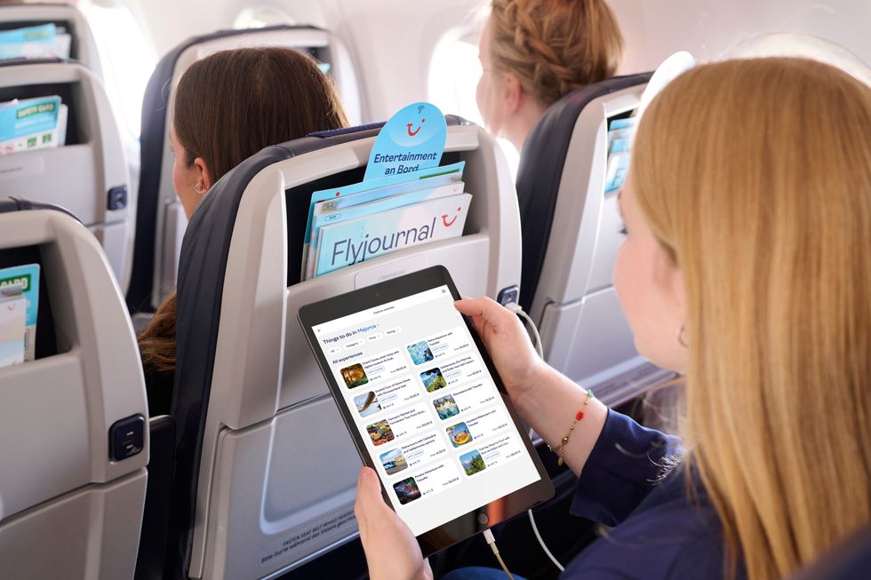 Woman holding tablet on TUI flight