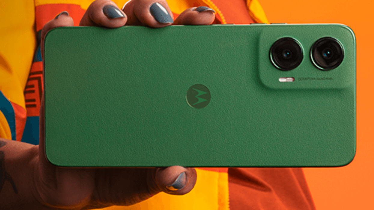 Woman holding the Motorola Moto G35 with a green case