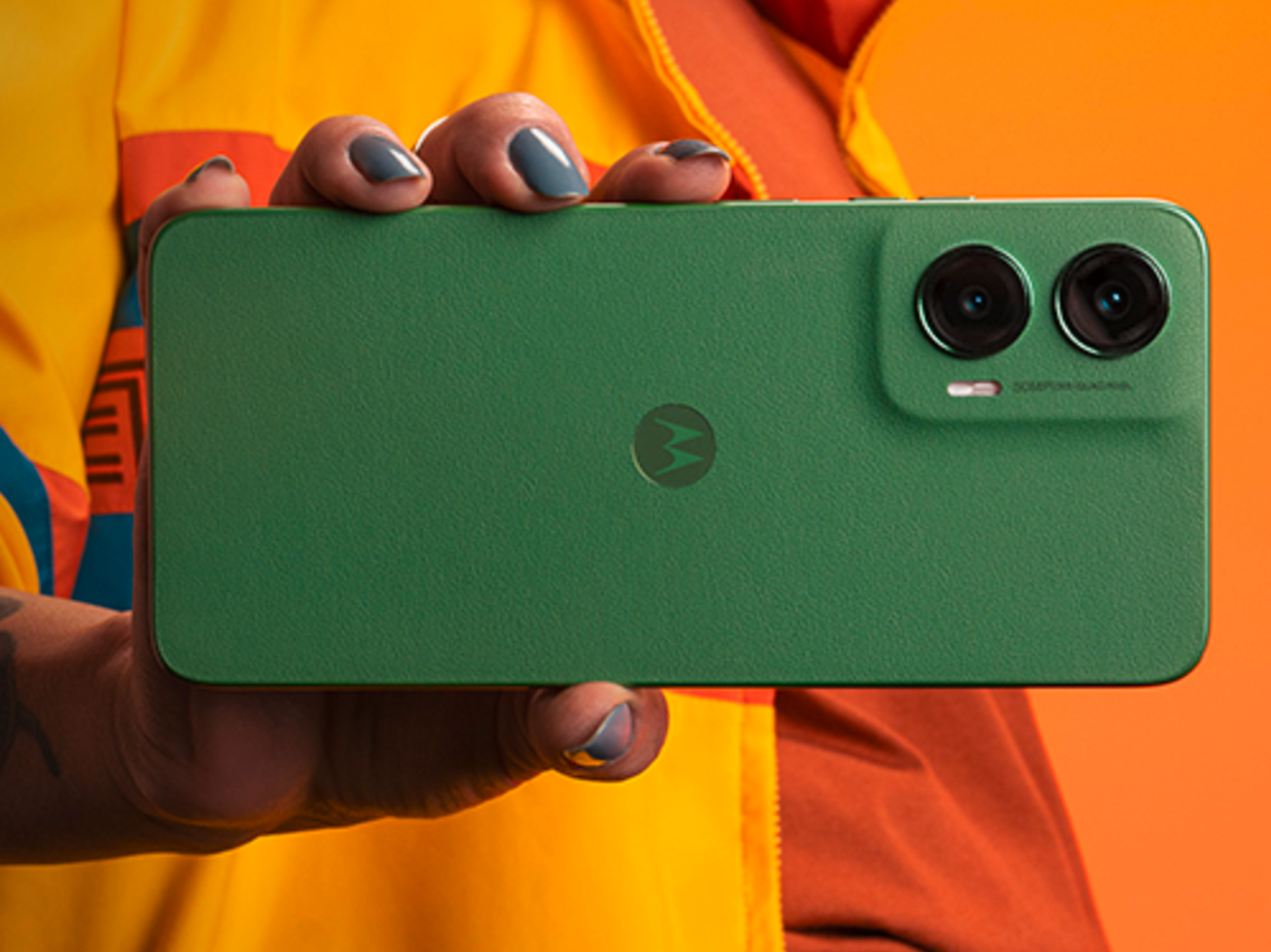 Woman holding the Motorola Moto G35 with a green case
