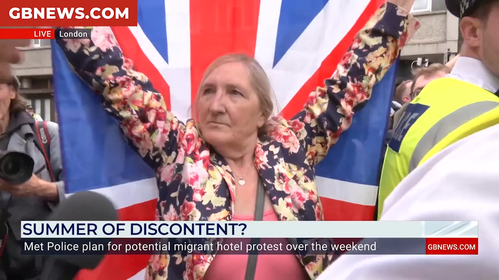 Woman holds aloft Union Jack flag