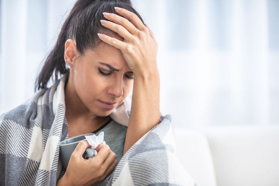 Woman ill holding head