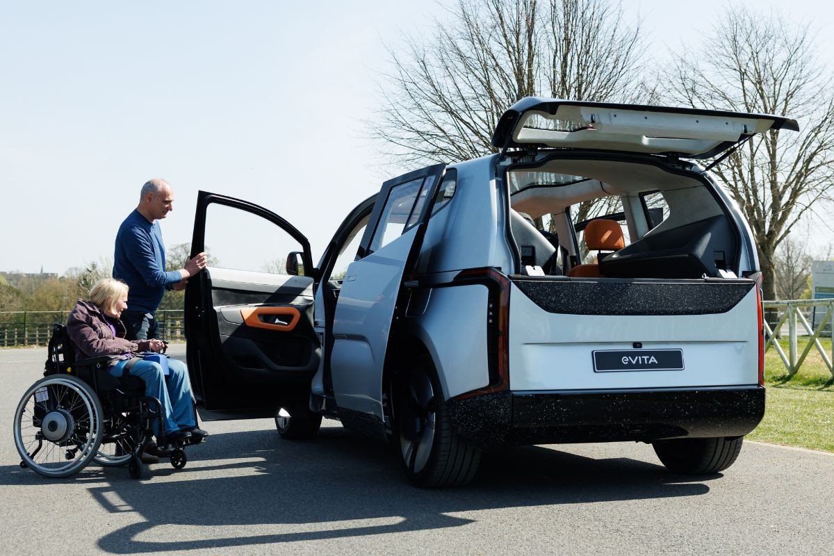 Woman in a wheelchair getting into an EV