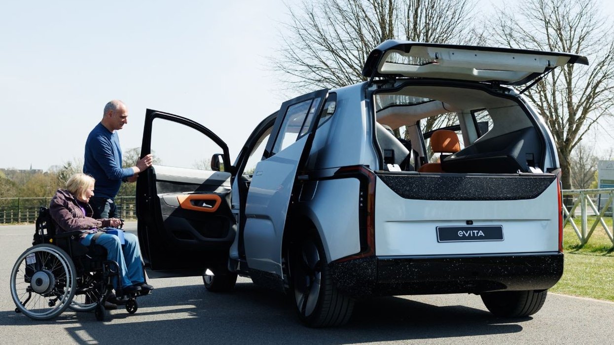 Woman in a wheelchair getting into an EV