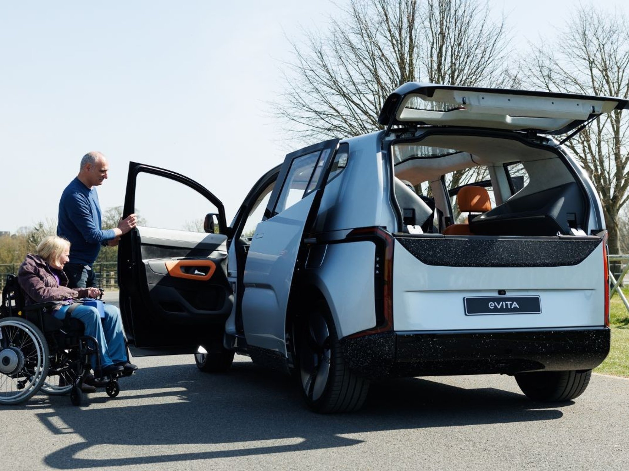 Woman in a wheelchair getting into an EV