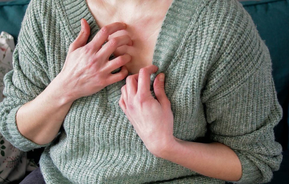 Woman itching her chest