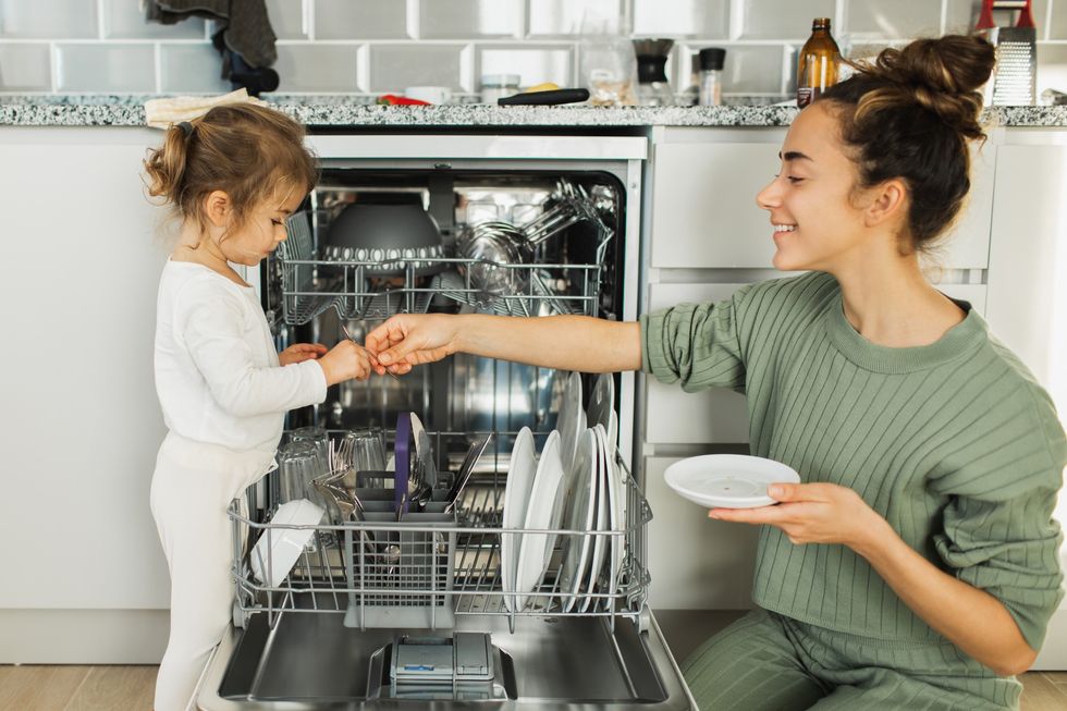 Woman loading the dishwasher