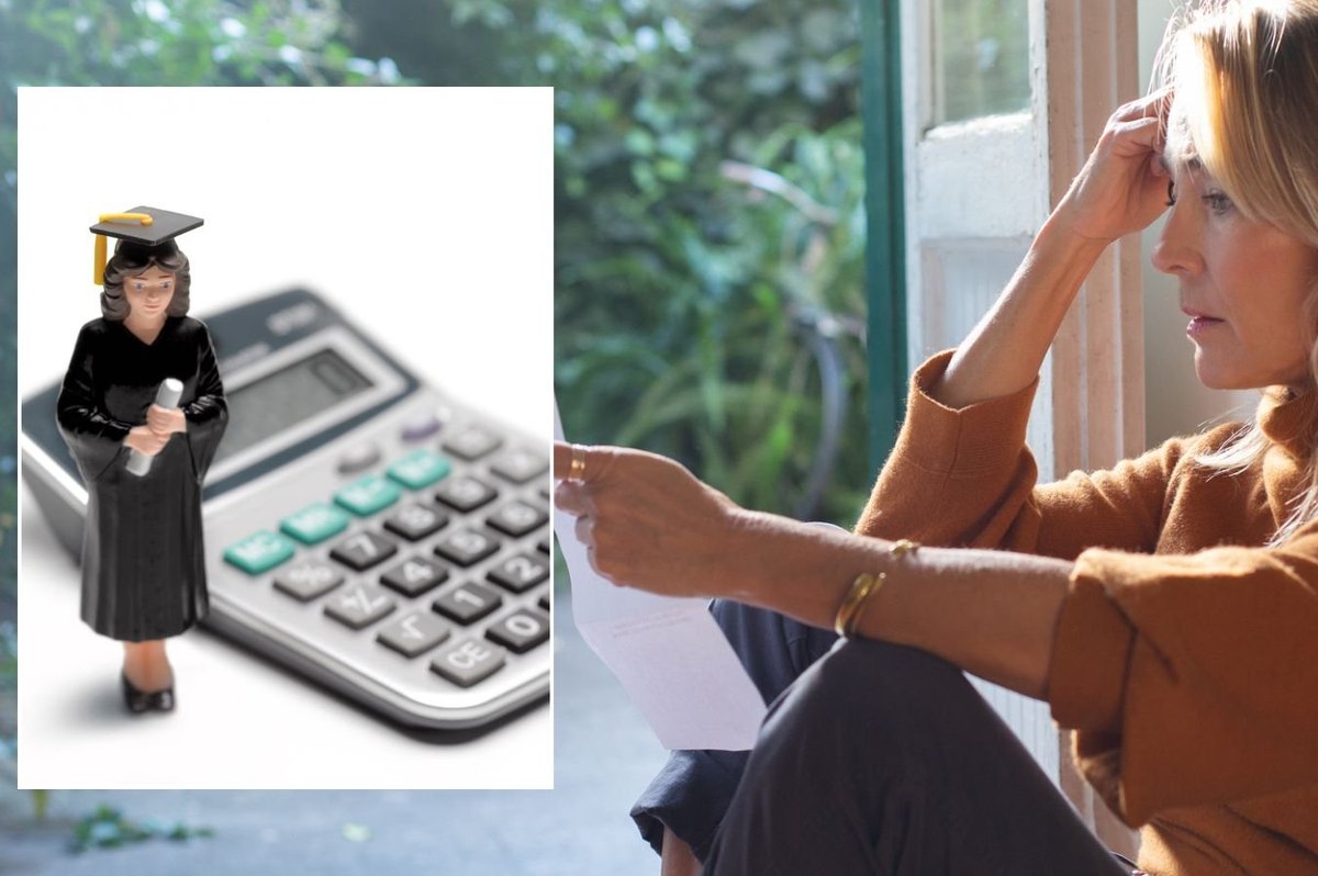 Woman looking at bill and calculator