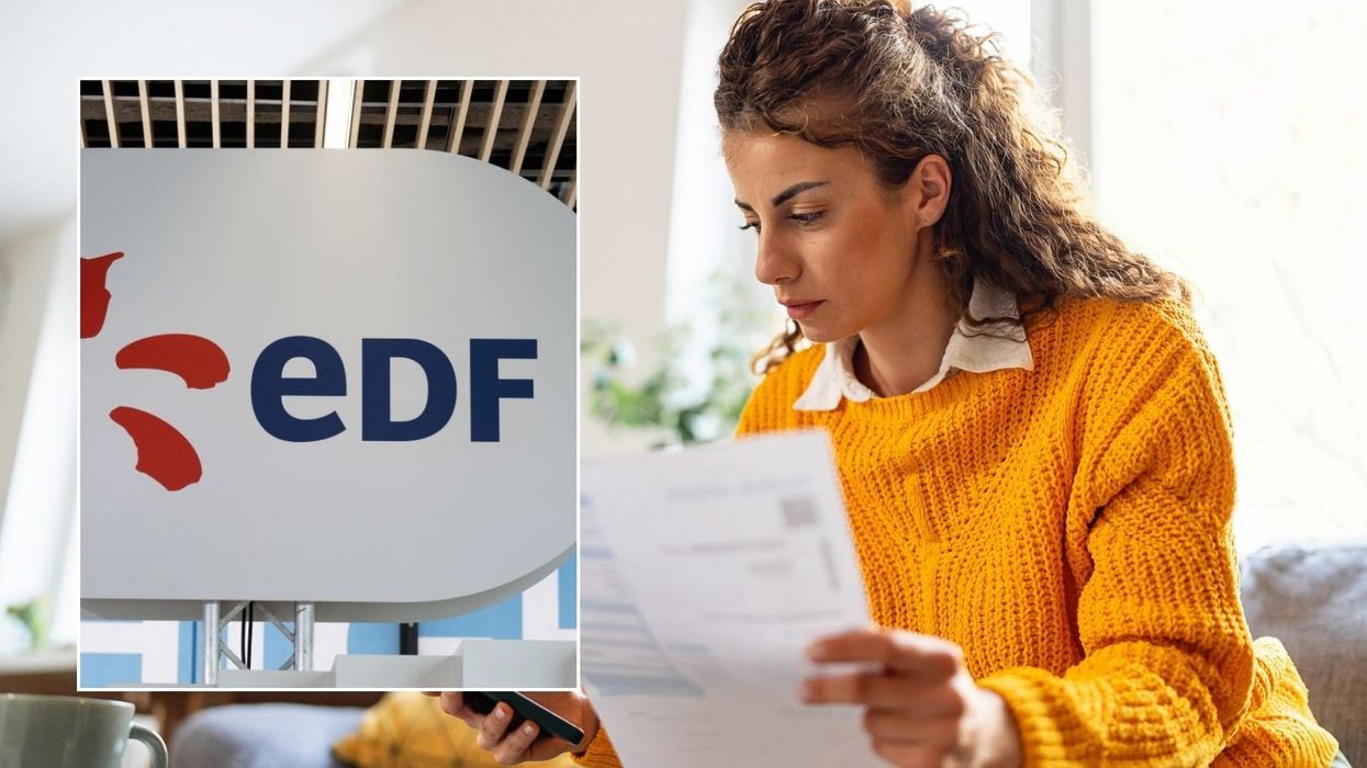 Woman looking at bill and EDF sign