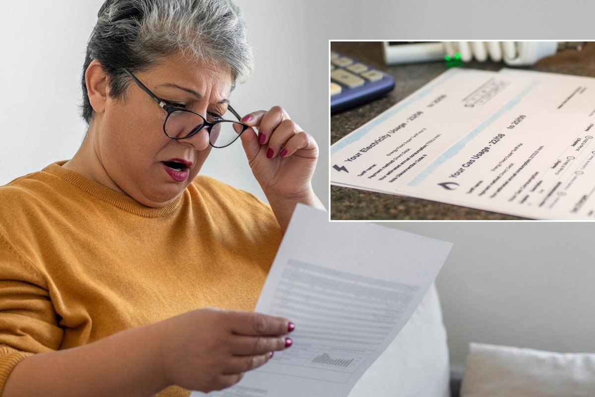 Woman looking at bill and energy bill