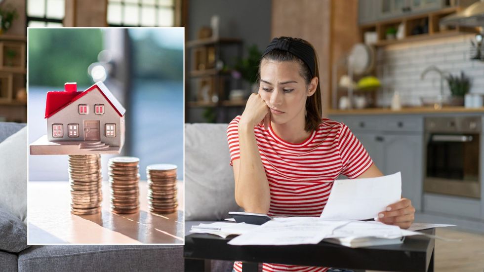 Woman looking at bill and money
