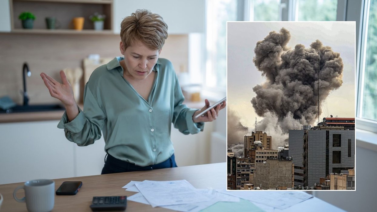 Woman looking at bills and explosion in Terhan, Iran