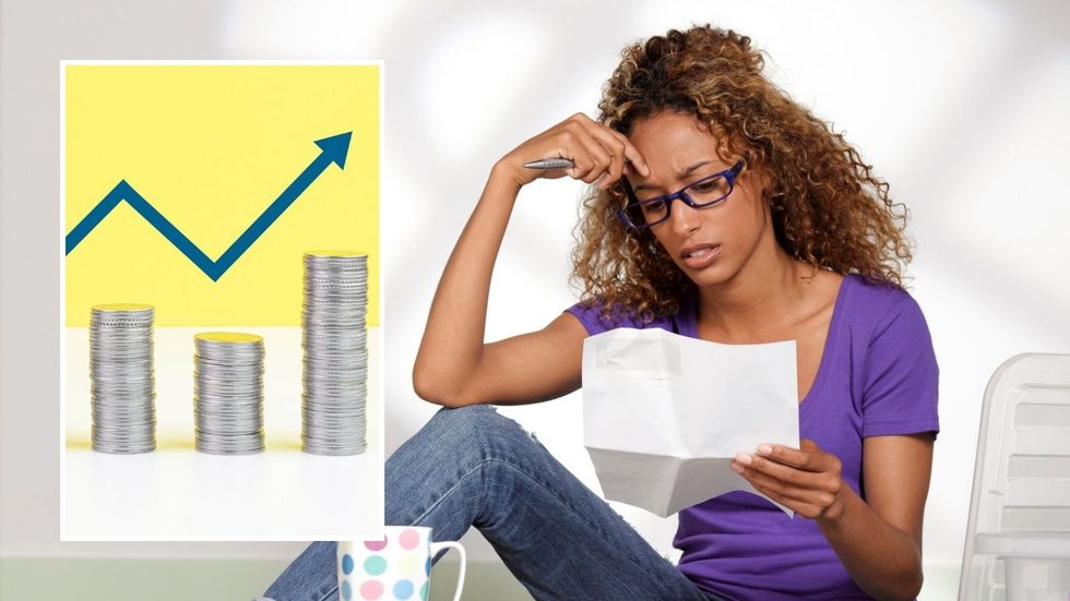 Woman looking at bills and interest rate rise