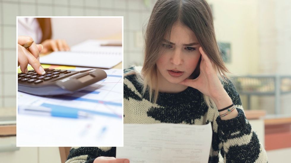 Woman looking at finances and calculator