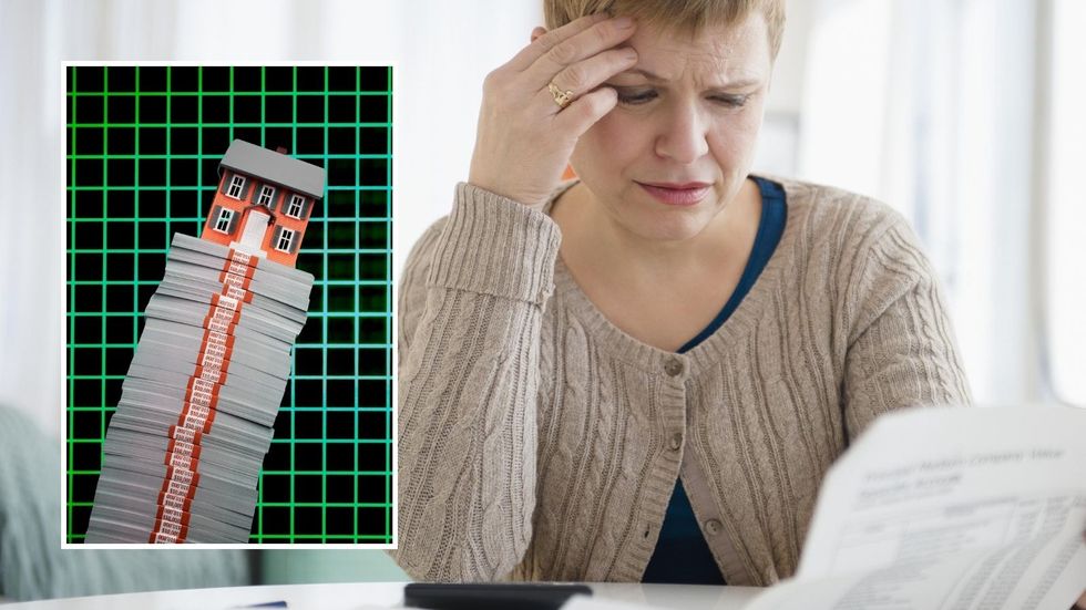 Woman looking at financial statement and mortgage bills