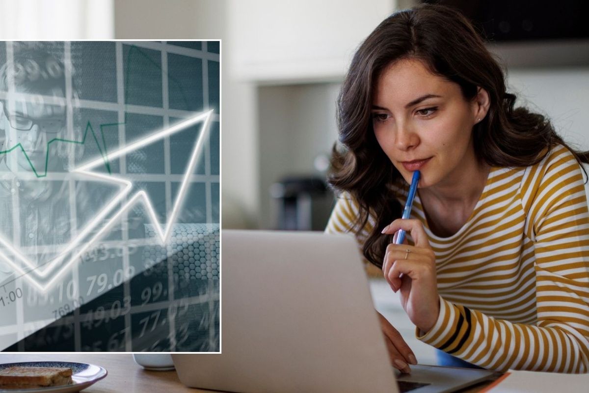 Woman looking at laptop and interest rate graph going up