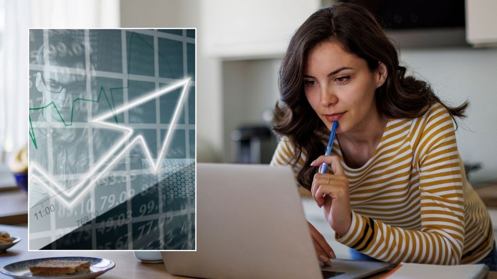Woman looking at laptop and interest rate graph going up
